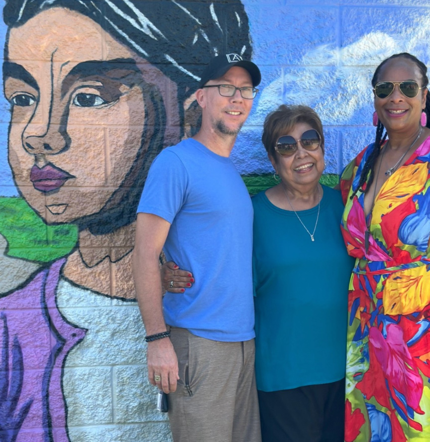 Minerva Delgado-Lopez, Bastrop City Council member Cheryl Lee, and artist Curtis Griffin in front of a mural painted in her honor at Delgado Park